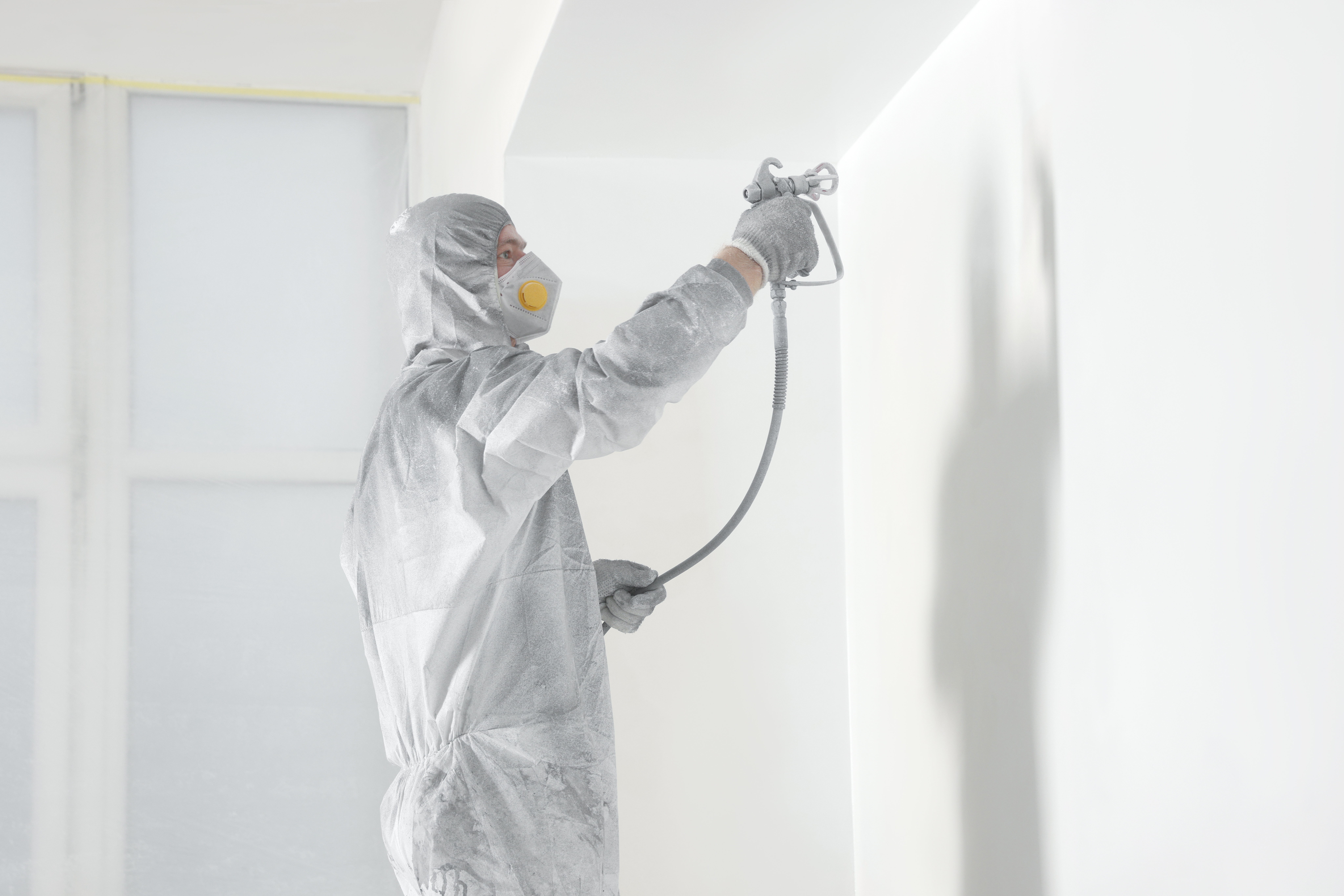 Spray painting large outdoor surface with even coverage